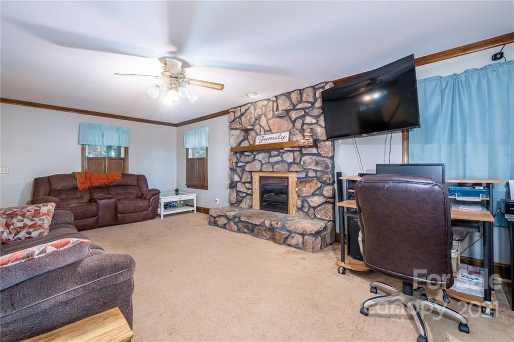 3810 Stack Road Monroe, NC 28112 - Photo 4 of 26 a living room with furniture a flat screen tv and a fireplace