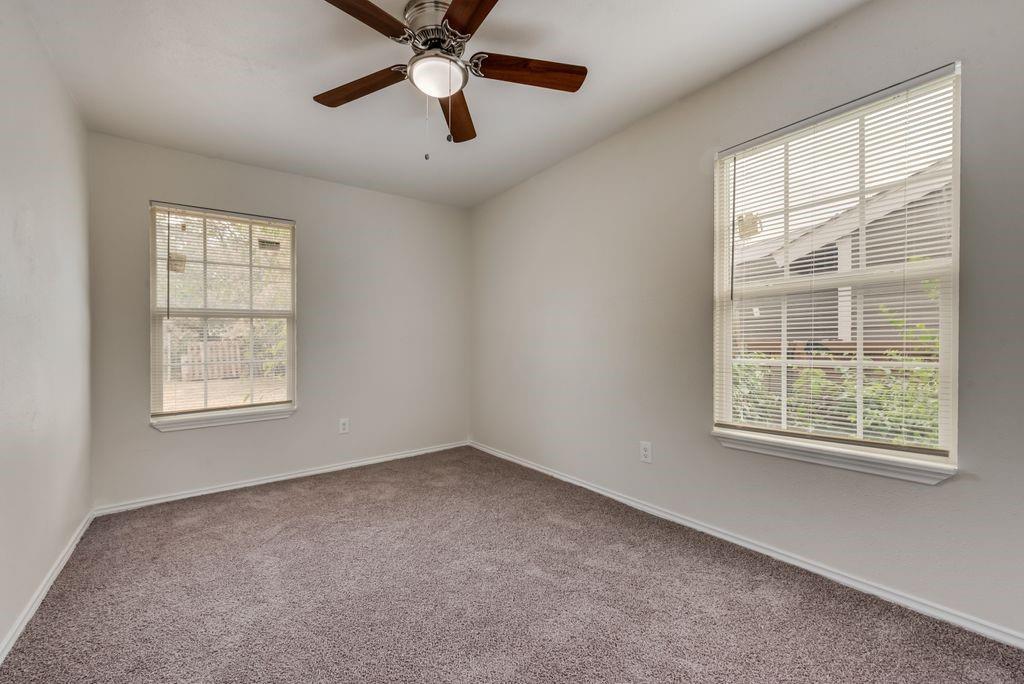 3005 Hatcher Street Fort Worth, TX 76105 - Photo 12 of 19 an empty room with a window and a ceiling fan