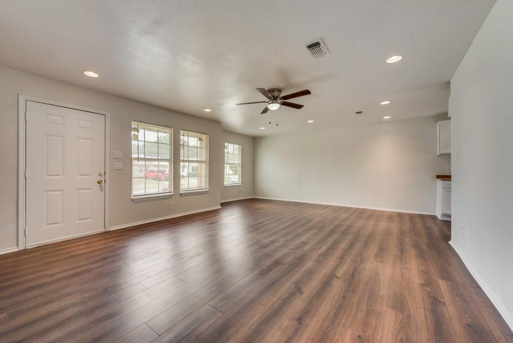 3005 Hatcher Street Fort Worth, TX 76105 - Photo 3 of 19 a view of an empty room with a window and wooden floor