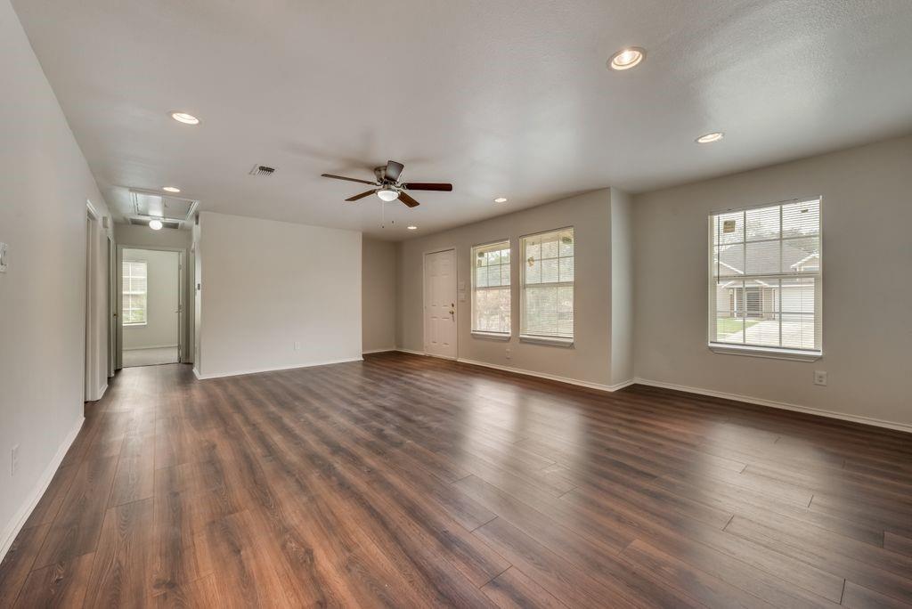 3005 Hatcher Street Fort Worth, TX 76105 - Photo 4 of 19 a view of an empty room with wooden floor and a window