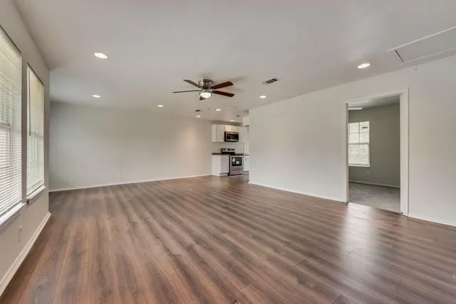 a kitchen with stainless steel appliances granite countertop a stove a sink and a microwave