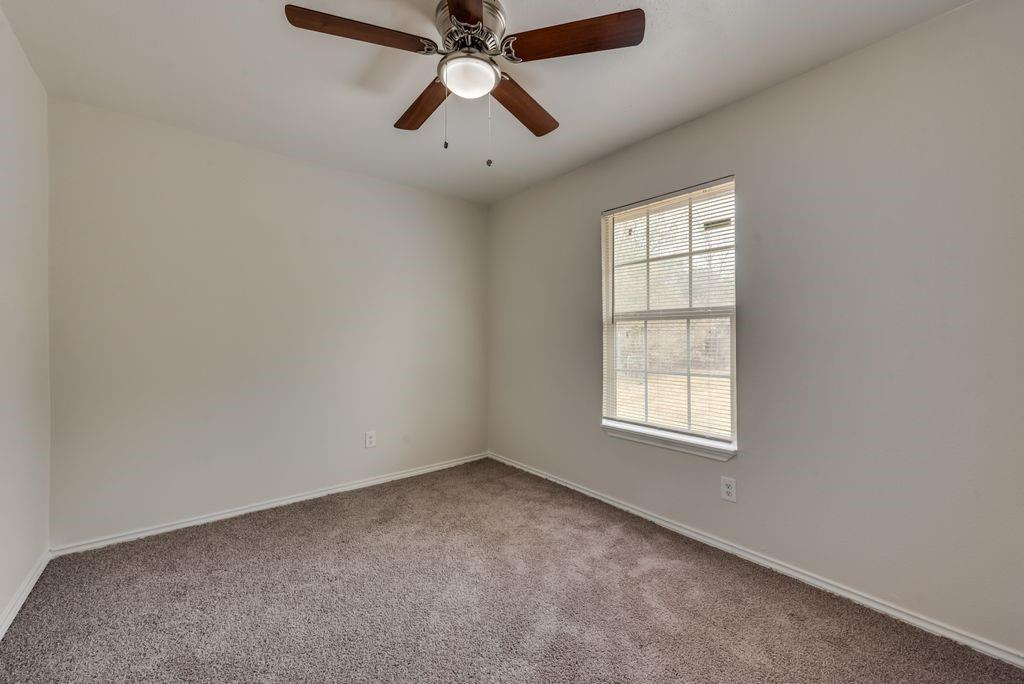 3005 Hatcher Street Fort Worth, TX 76105 - Photo 9 of 19 an empty room with windows and fan