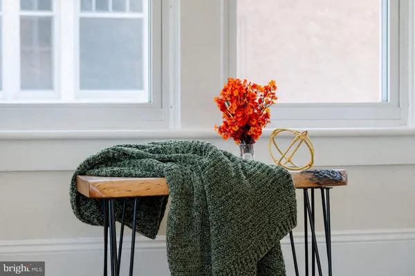 a table with a vase and flowers on it