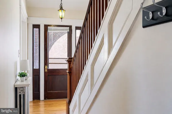 a view of a hallway with wooden floor and entryway