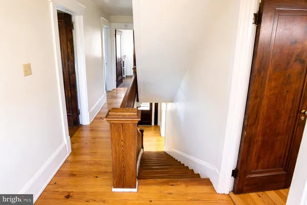 a view of a hallway with wooden floor