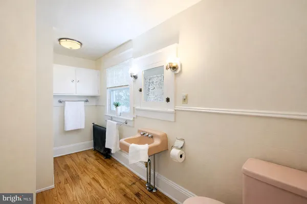 a bathroom with a sink a toilet and mirror