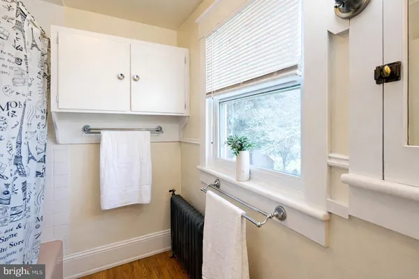 a bathroom with a bathtub and a window