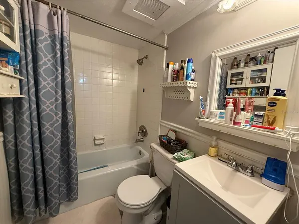a bathroom with a sink toilet vanity and shower