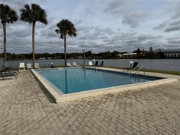 a view of a swimming pool with a chair and tables