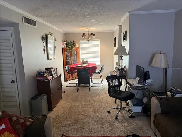 a livingroom with workspace and a couch