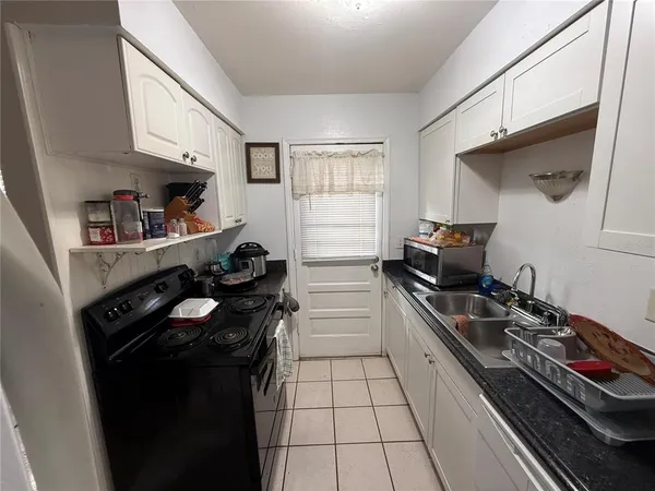 a kitchen with a sink stove and cabinets