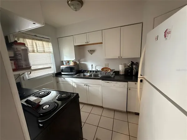 a kitchen with a refrigerator a stove a sink and a stove