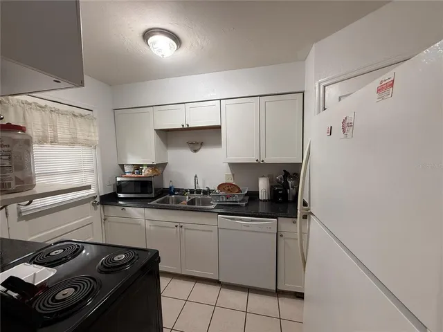 a kitchen with stainless steel appliances a sink and a stove