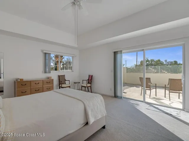 a bedroom with a large bed and a large window