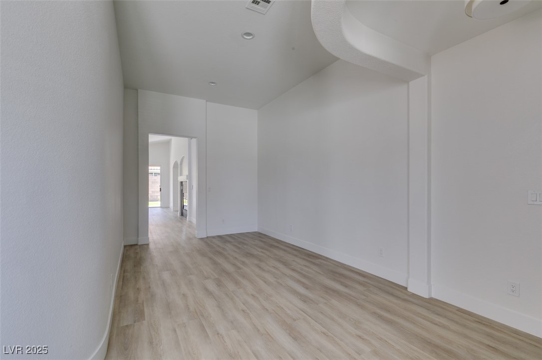 823 Wintersweet Road Henderson, NV 89015 - Photo 14 of 50 Spare room with light wood finished floors and baseboards