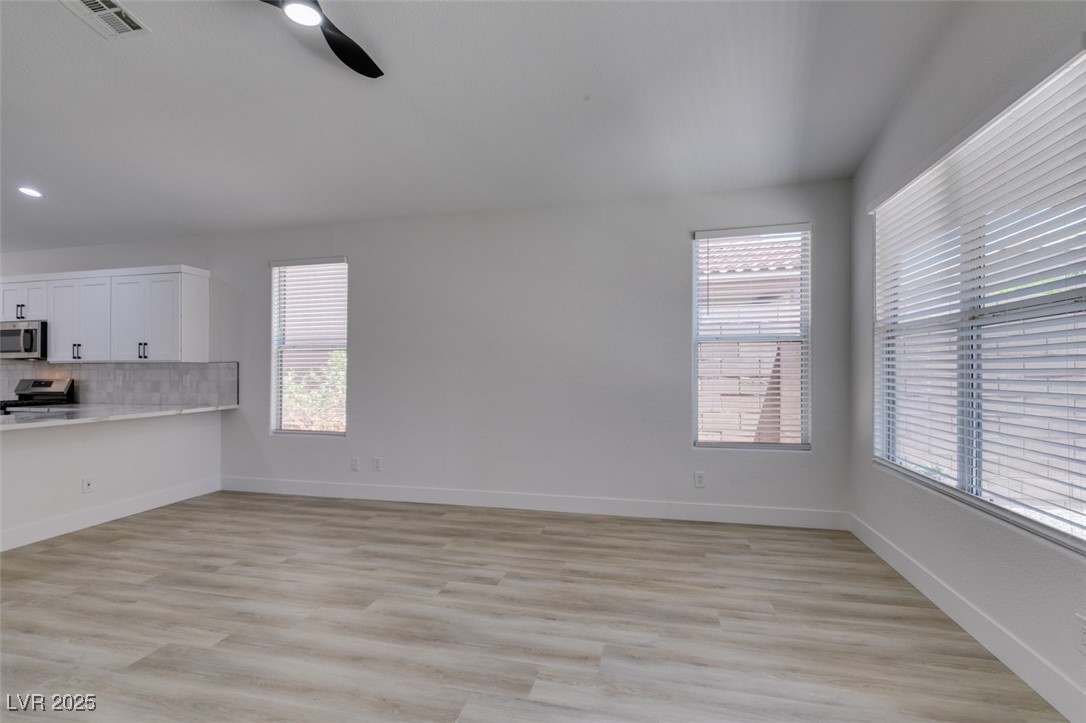 823 Wintersweet Road Henderson, NV 89015 - Photo 21 of 50 Unfurnished dining area featuring light wood-type flooring and ceiling fan