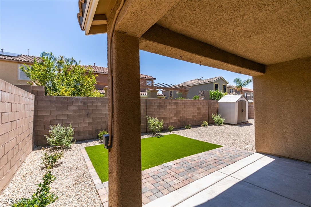 823 Wintersweet Road Henderson, NV 89015 - Photo 44 of 50 Fenced backyard featuring a patio and a shed