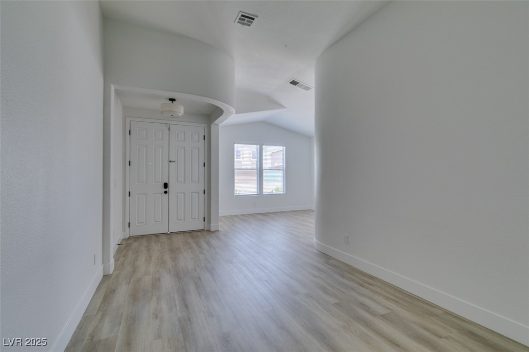 823 Wintersweet Road Henderson, NV 89015 - Photo 5 of 50 Entryway featuring light wood-style floors and vaulted ceiling