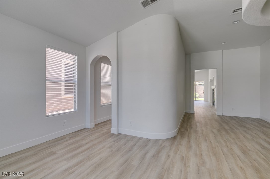 823 Wintersweet Road Henderson, NV 89015 - Photo 10 of 50 Empty room with light wood-type flooring and baseboards