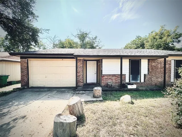 a front view of a house with a yard outdoor seating and garage