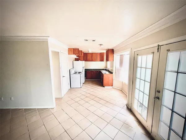 a room with a bed and a large window