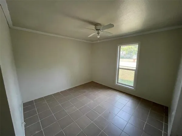a view of an empty room and a window