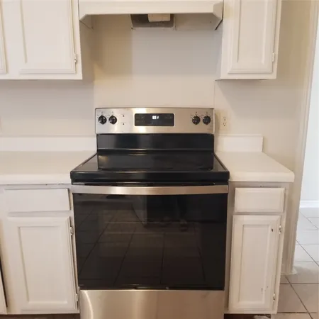 a kitchen with a sink cabinets and window