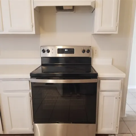 a kitchen with a sink cabinets and window