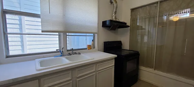 a kitchen with a sink and a refrigerator