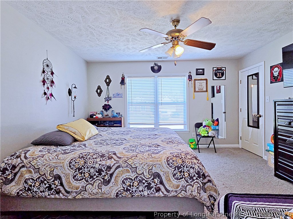5218 Pringle Way Hope Mills, NC 28348 - Photo 23 of 43 a bedroom with a bed dresser and a window