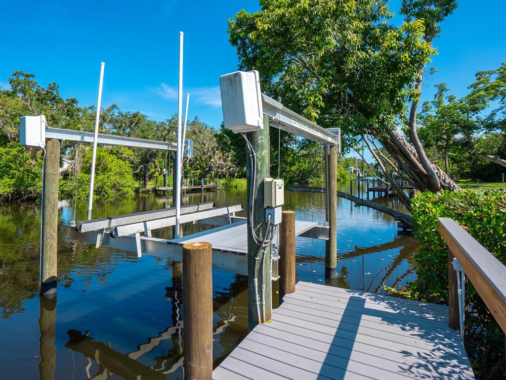 2504 Wilkinson Road Sarasota, FL 34231 - Photo 8 of 12 a view of balcony with wooden floor and outdoor seating