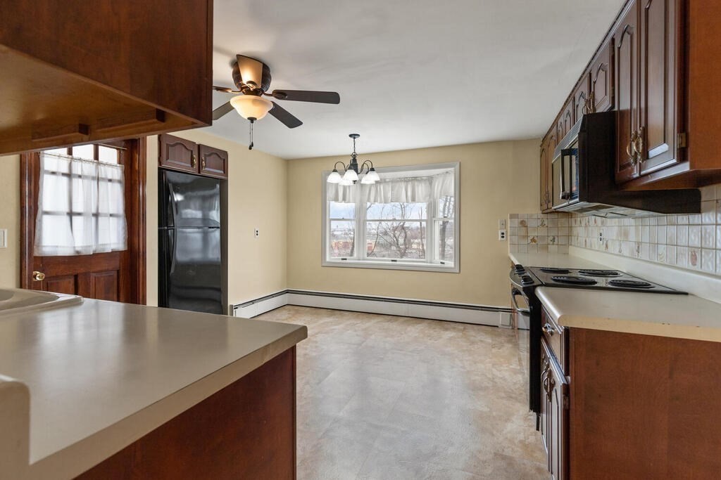 148 Ridge Road Revere, MA 02151 - Photo 11 of 31 a view of a kitchen with a sink cabinets and outdoor space