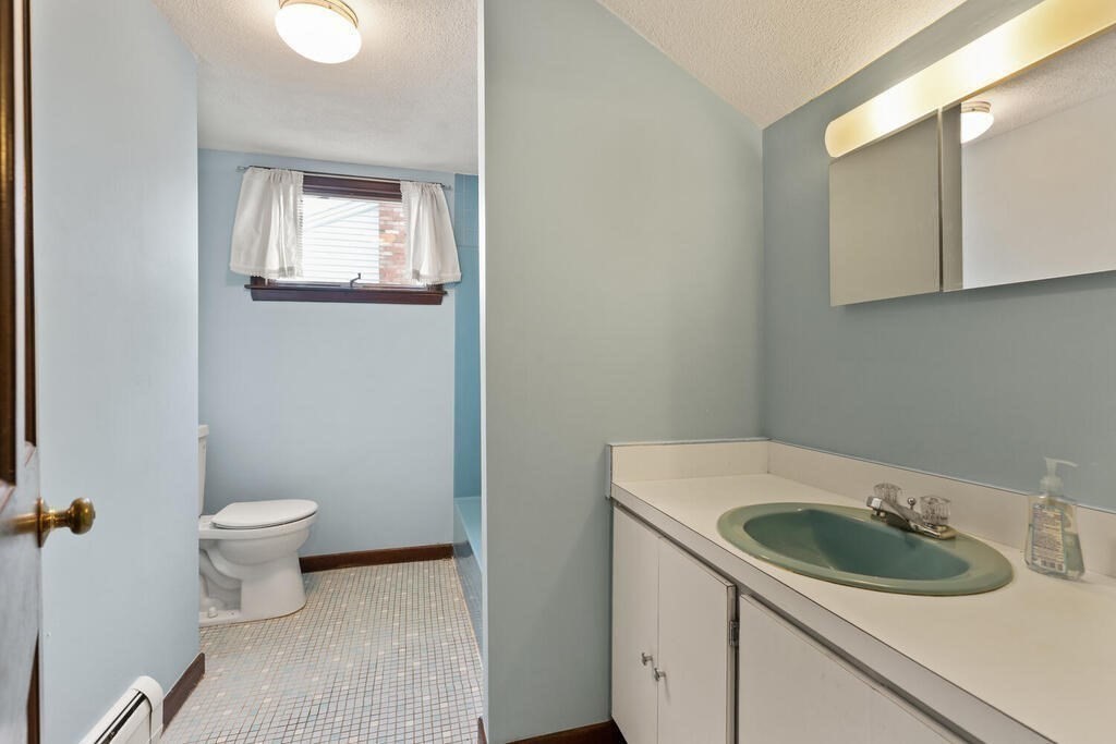 148 Ridge Road Revere, MA 02151 - Photo 23 of 31 a bathroom with a granite countertop sink and a toilet
