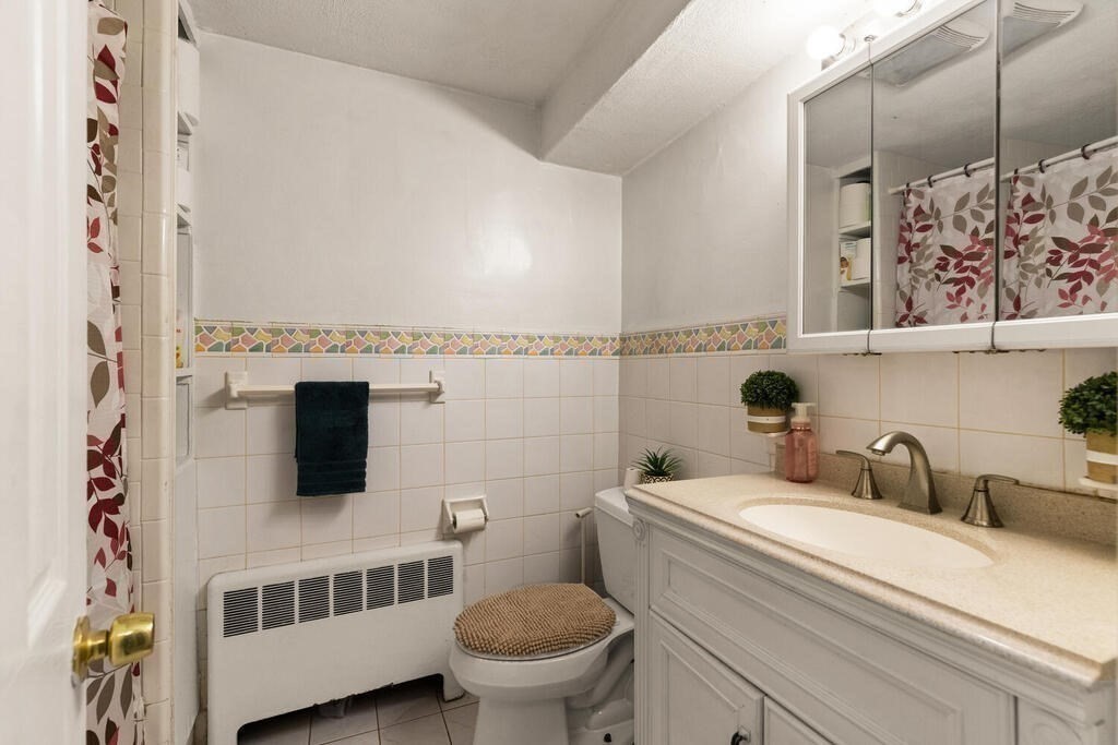 148 Ridge Road Revere, MA 02151 - Photo 24 of 31 a bathroom with a toilet a sink and a shower