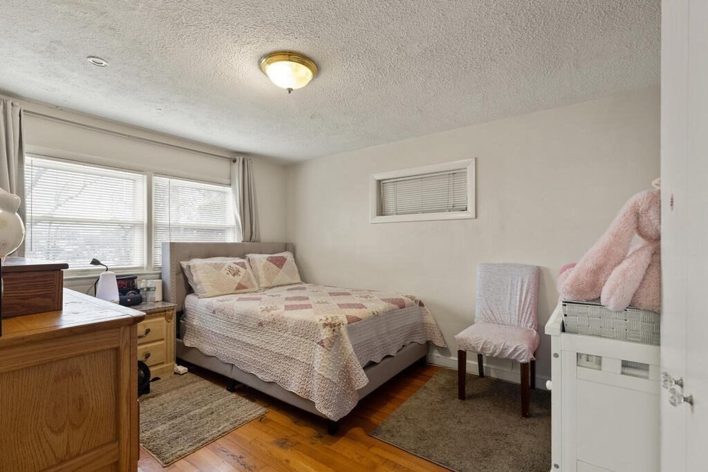 148 Ridge Road Revere, MA 02151 - Photo 27 of 31 a bedroom with a bed and a night stand