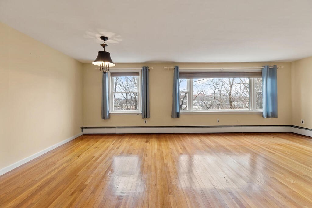 148 Ridge Road Revere, MA 02151 - Photo 6 of 31 wooden floor in an empty room with a window