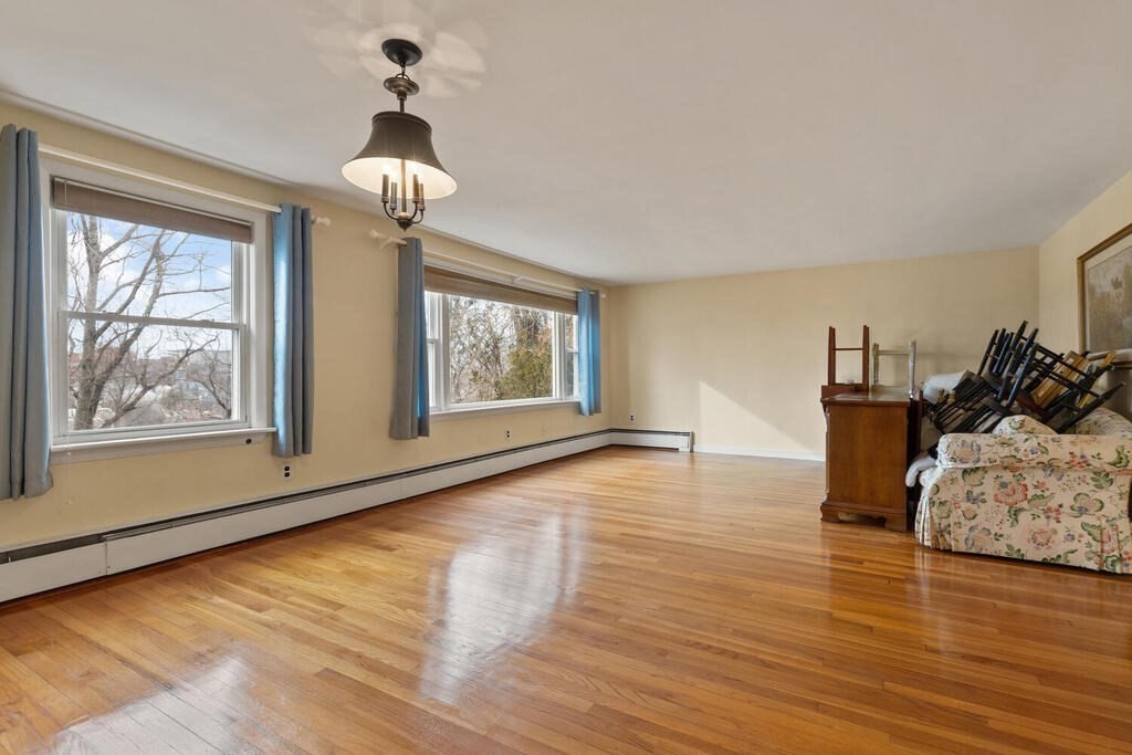 148 Ridge Road Revere, MA 02151 - Photo 7 of 31 a view of empty room with wooden floor and fan