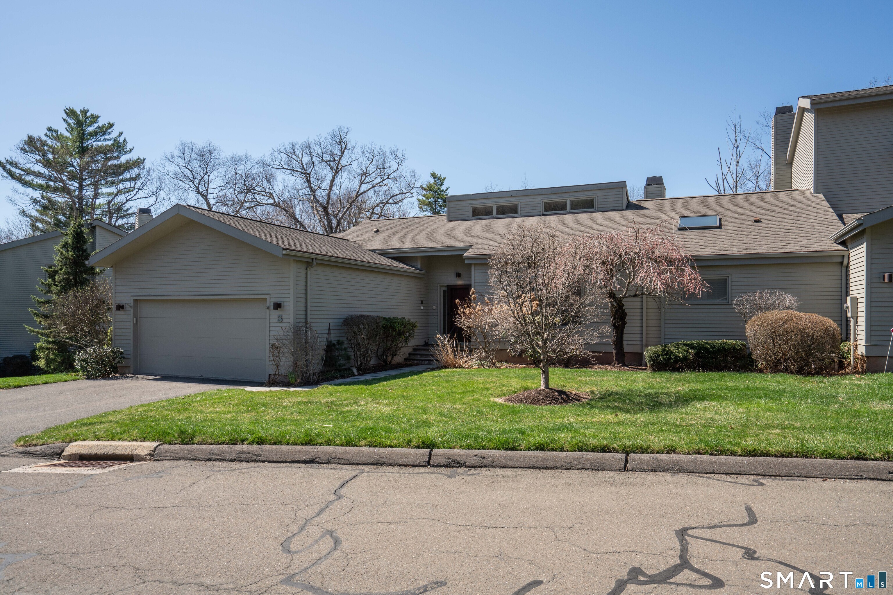 a aerial view of a house with a yard and a garage