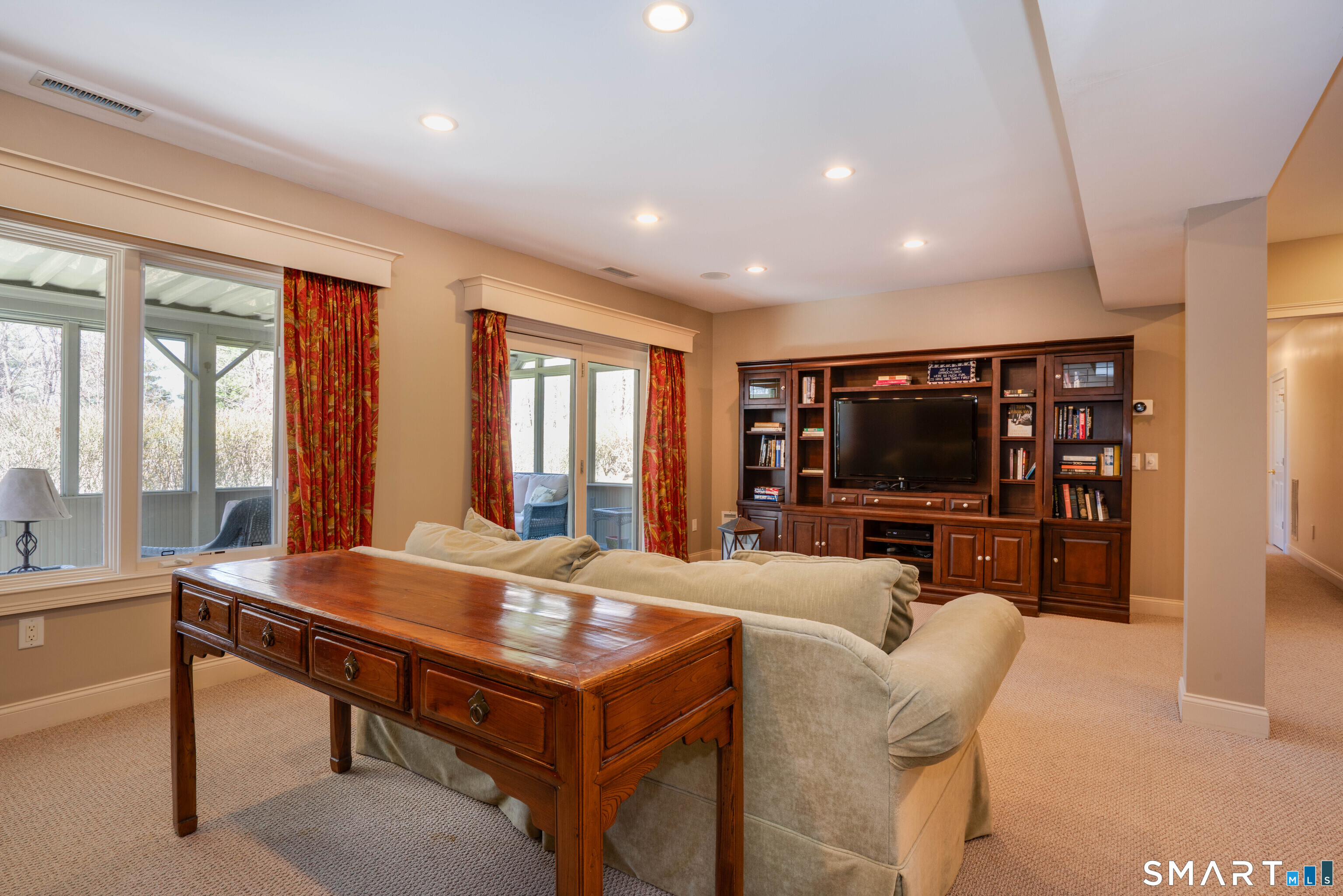 3 Shirecrest, Unit 3 Avon, CT 06001 - Photo 23 of 32 a living room with furniture a flat screen tv and a large window