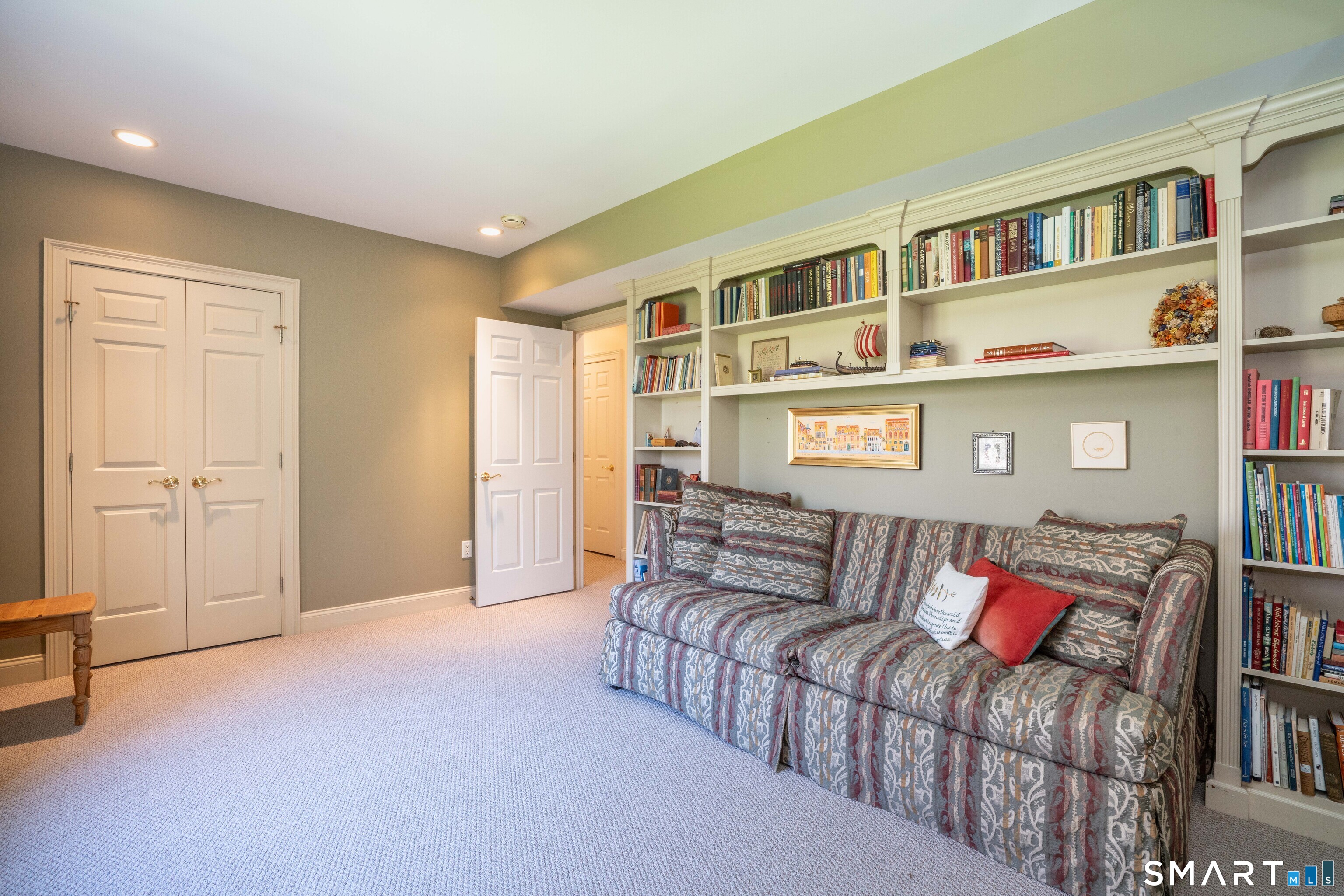3 Shirecrest, Unit 3 Avon, CT 06001 - Photo 24 of 32 a living room with furniture and a book shelf