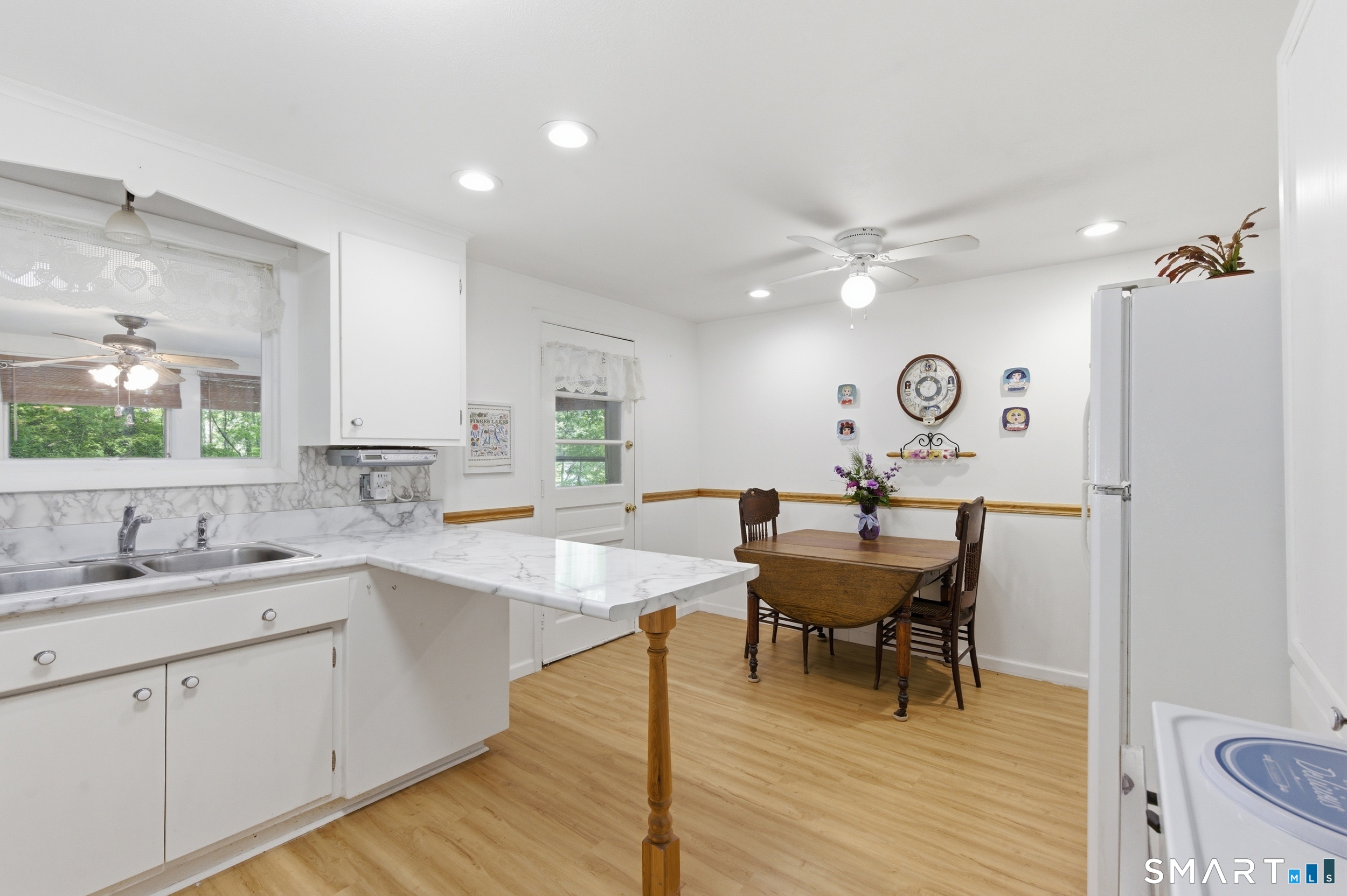 121 River Road Preston, CT 06365 - Photo 9 of 37 a view of a kitchen area with furniture and wooden floor