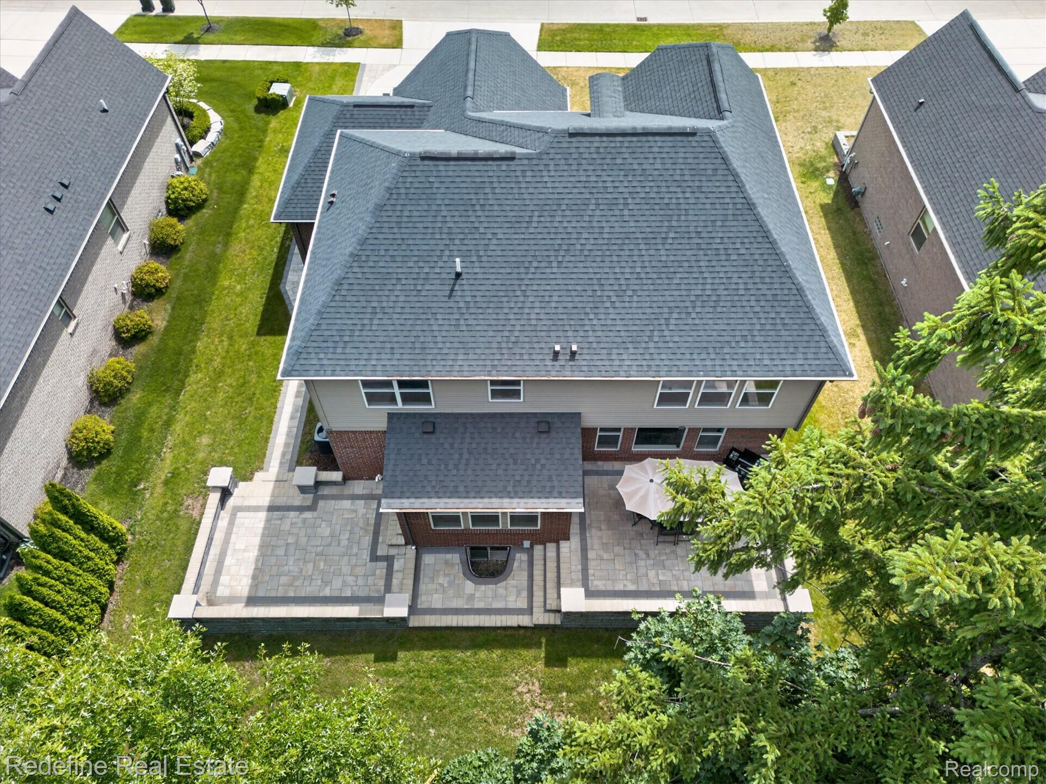 2976 Andlaur Drive Rochester, MI 48307 - Photo 3 of 60 Expansive paver patio with a tiered design and integrated fire pit