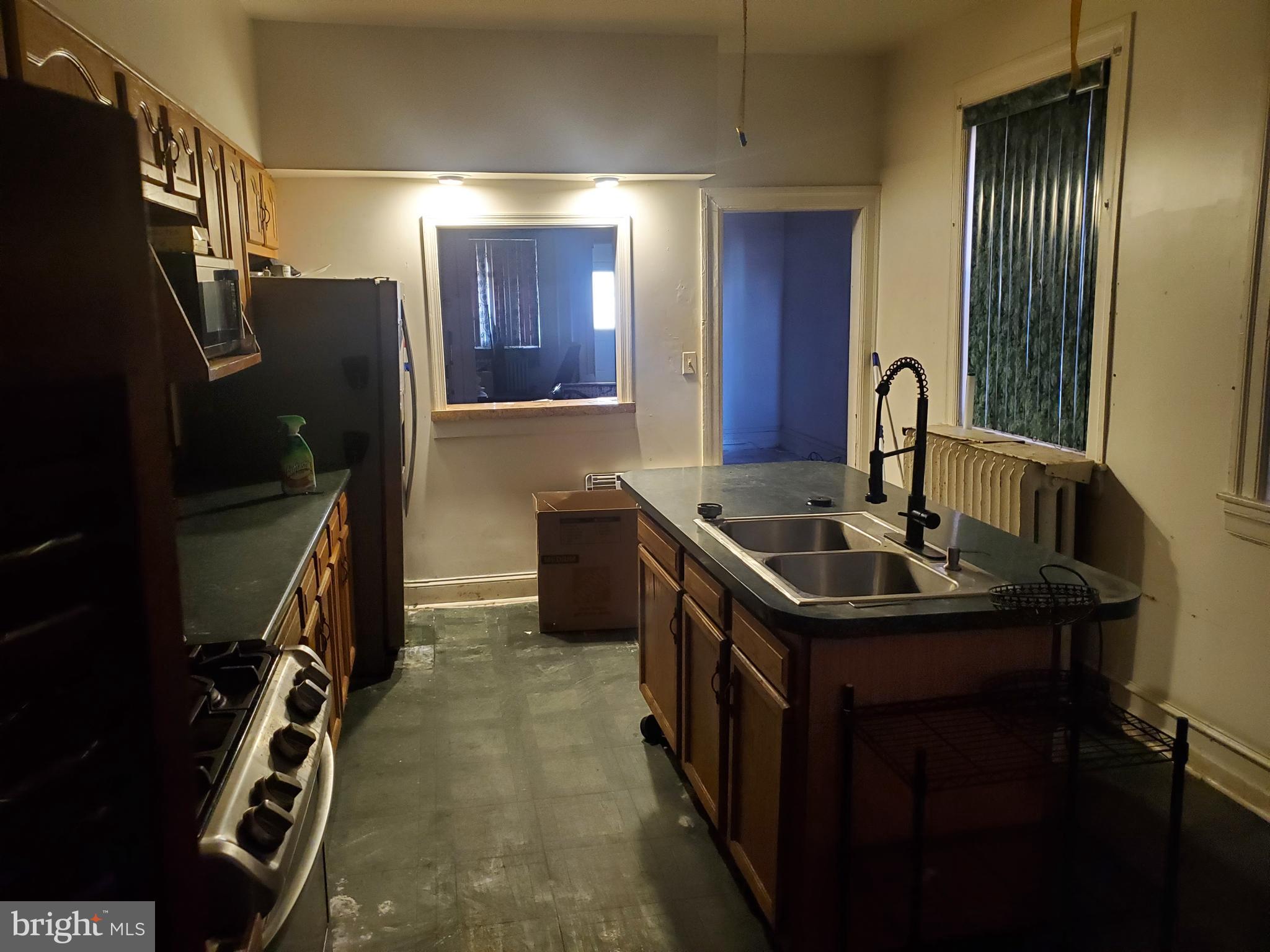 6058 Webster Street Philadelphia, PA 19143 - Photo 5 of 15 a kitchen with a sink stove and refrigerator