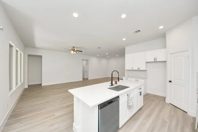 a large white kitchen with a sink