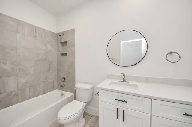 a bathroom with a sink a toilet and a mirror