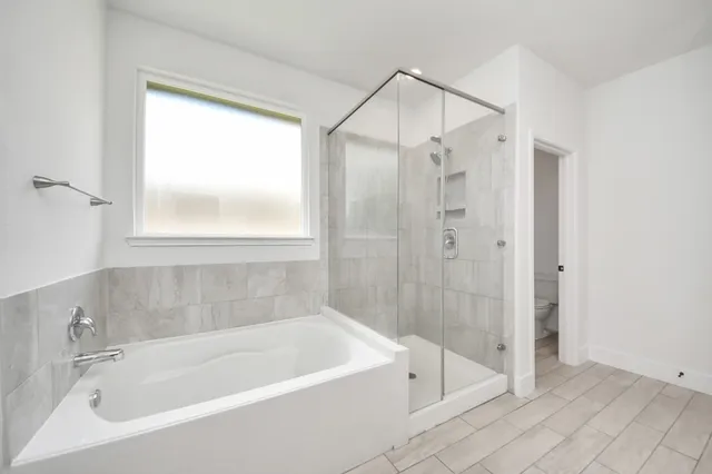 a white bath tub sitting next to a shower