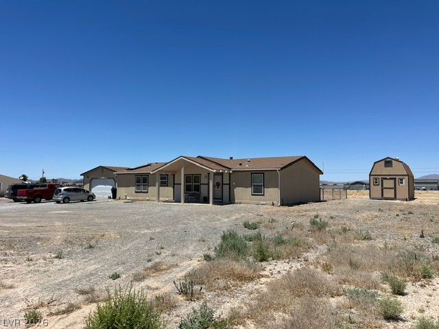 350 East Stagecoach Road Pahrump, NV 89060 - Photo 4 of 4 A spacious desert home offering ample parking and a versatile shed for extra storage.