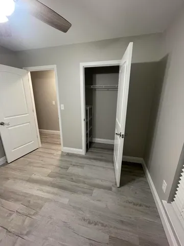 wooden floor in an empty room with a mirror