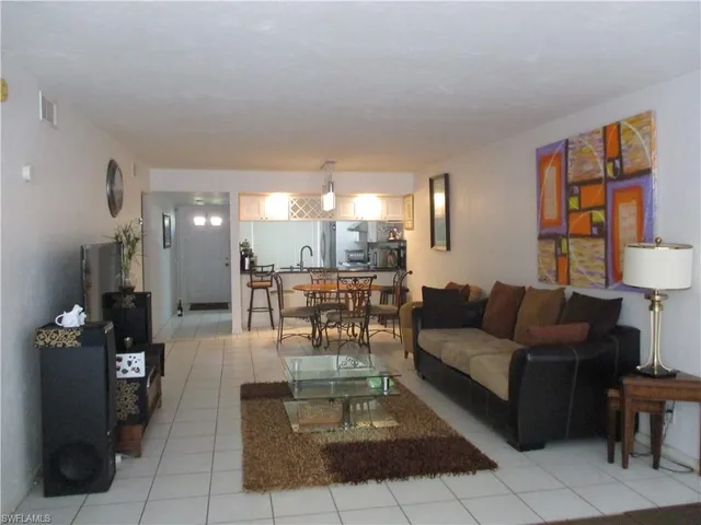 a living room with furniture and a lamp