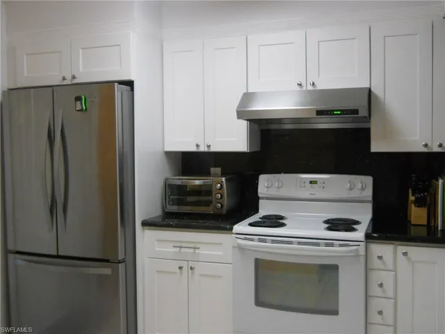 a kitchen with a stove and a refrigerator